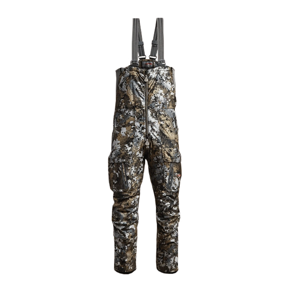 Camouflage Sitka Incinerator bib overalls with gray adjustable suspenders, shown flat against a solid white background.